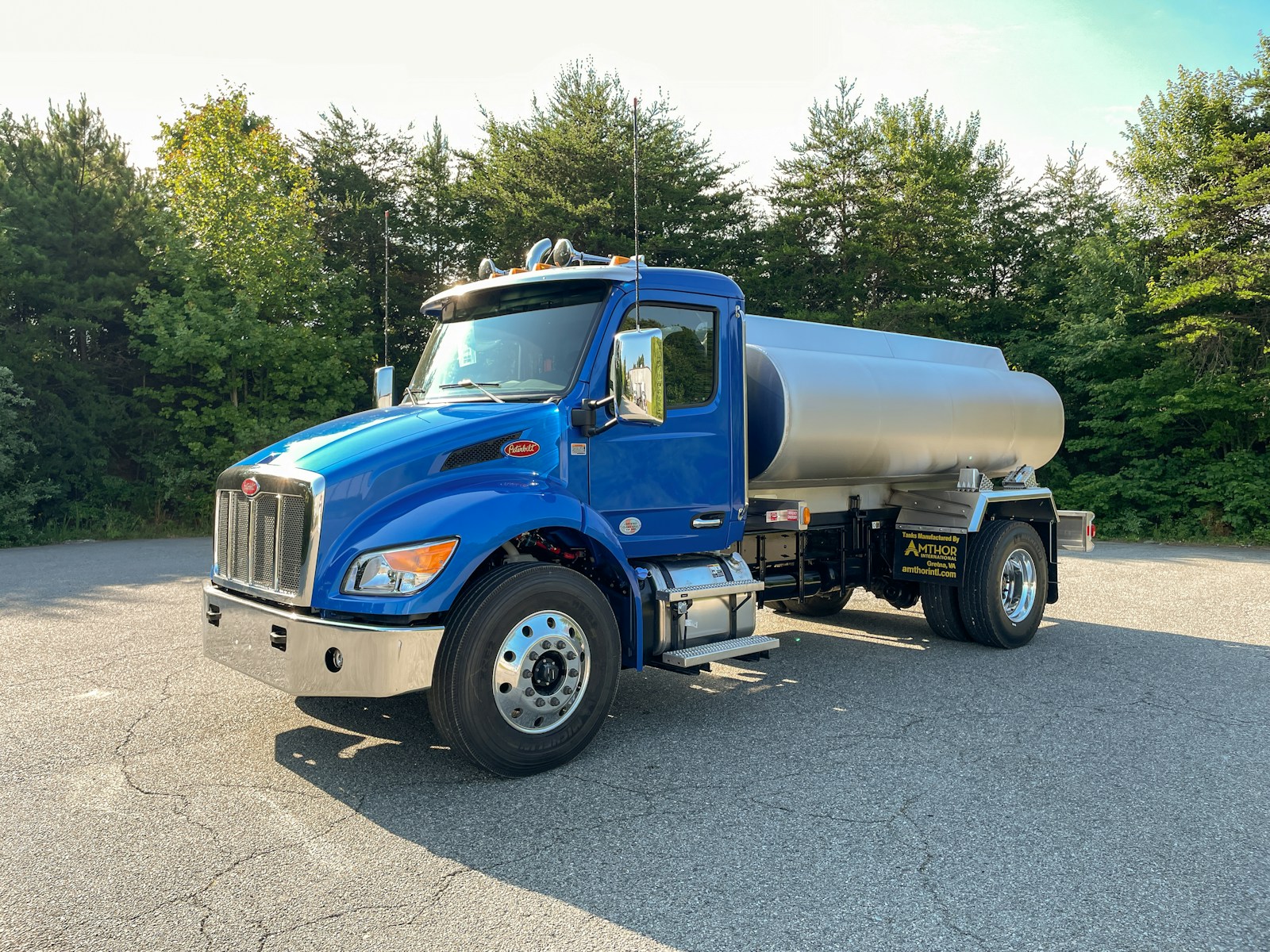 A large blue truck parked in a parking lot