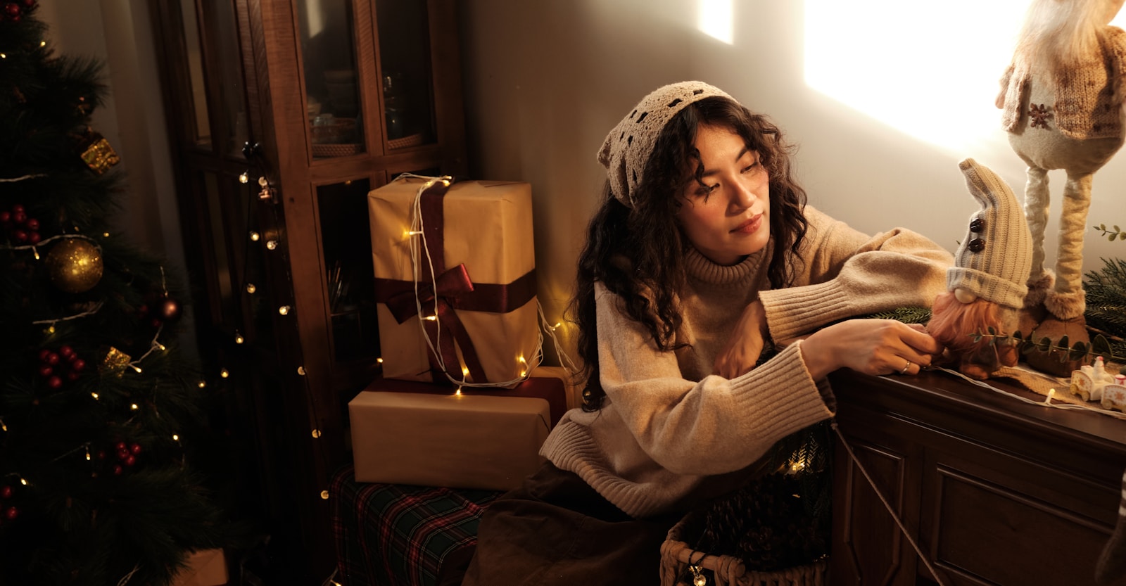 Woman in cozy sweater with christmas decorations