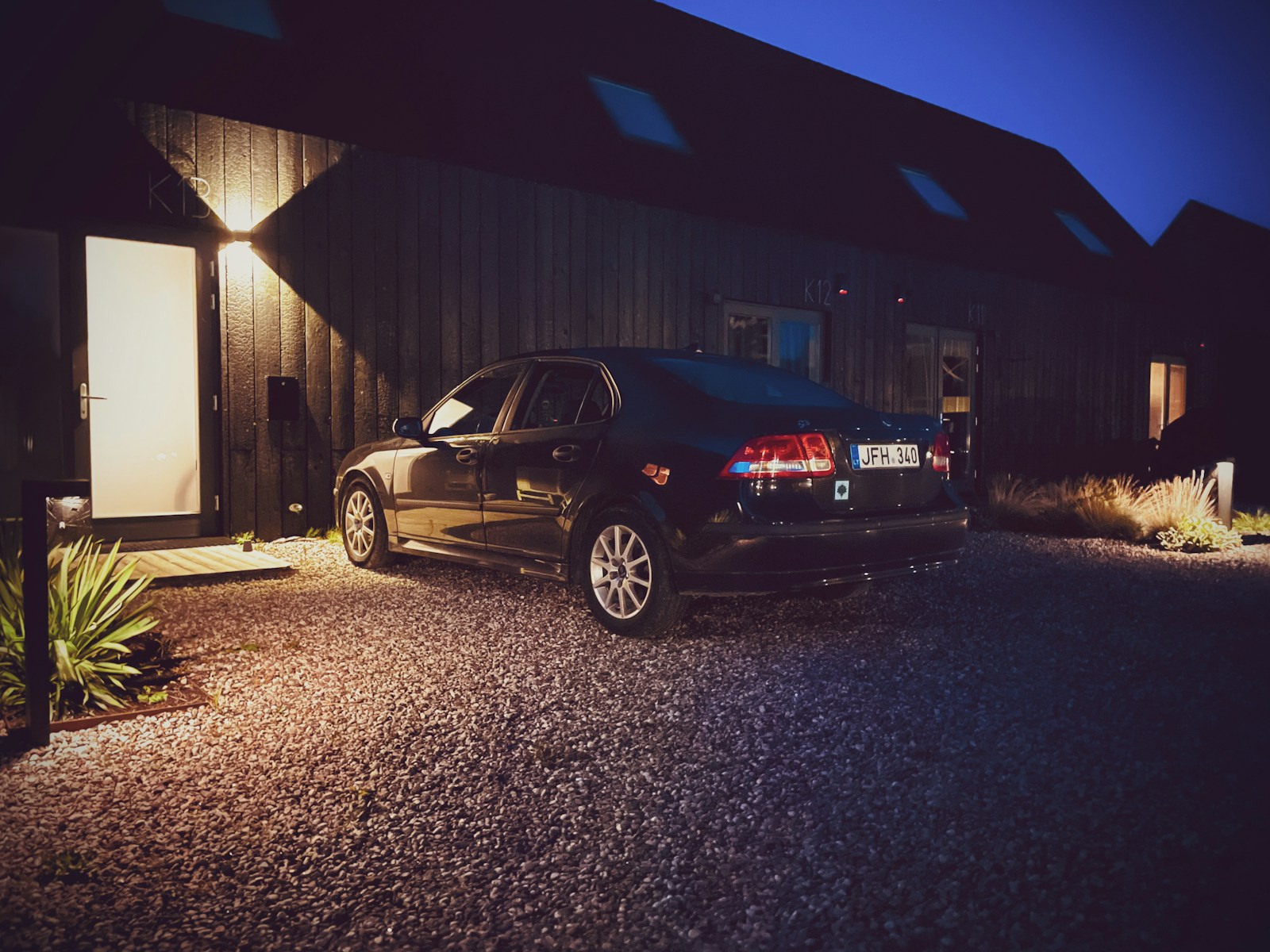 a car parked in front of a building at night