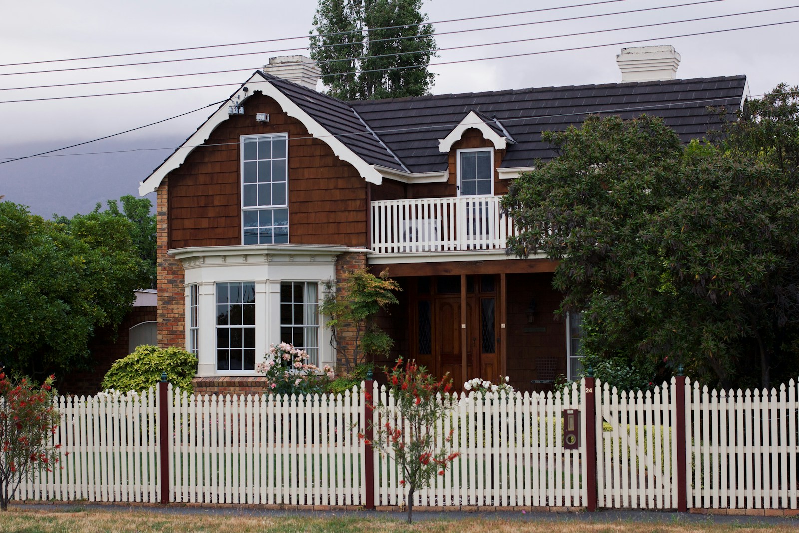 A house with a white picket fence in front of it