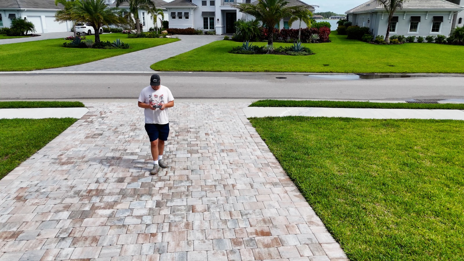 A man running down a sidewalk in a neighborhood
