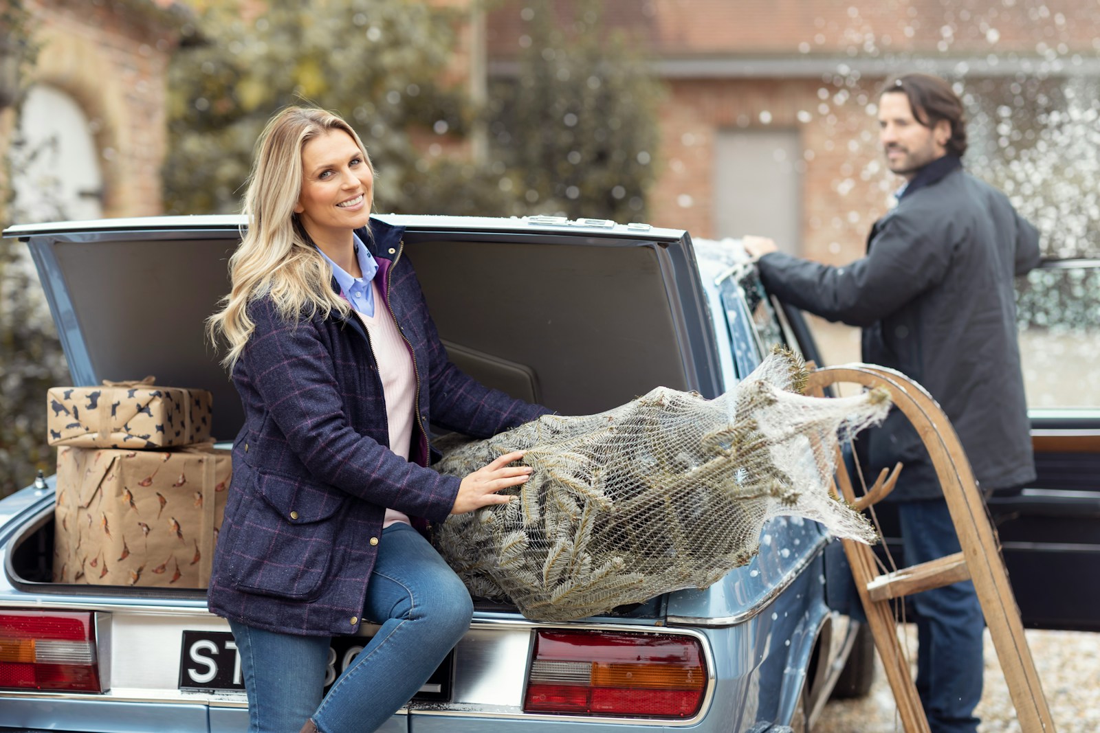 a woman sitting on the back of a truck