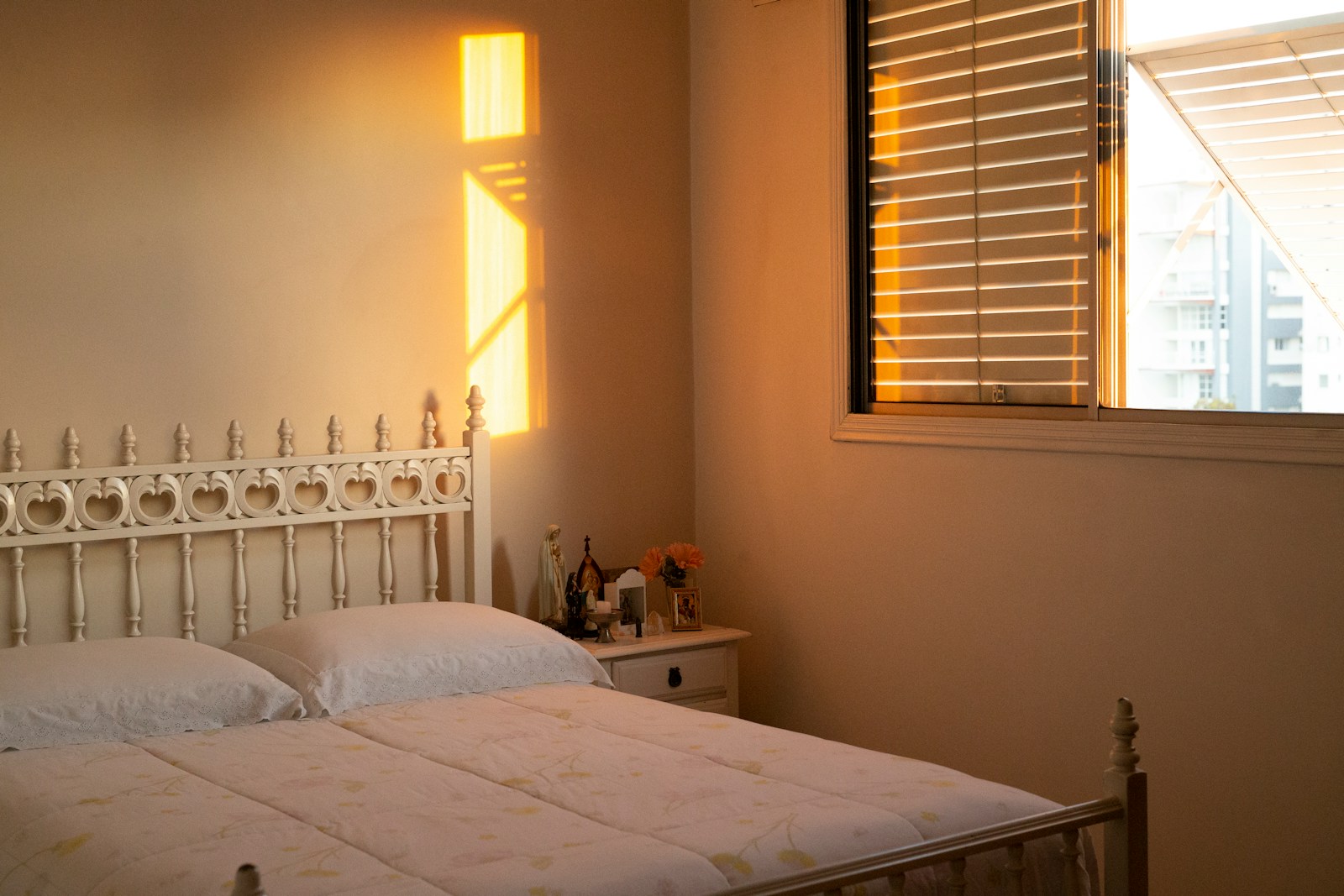 a bedroom with a white bed and a window
