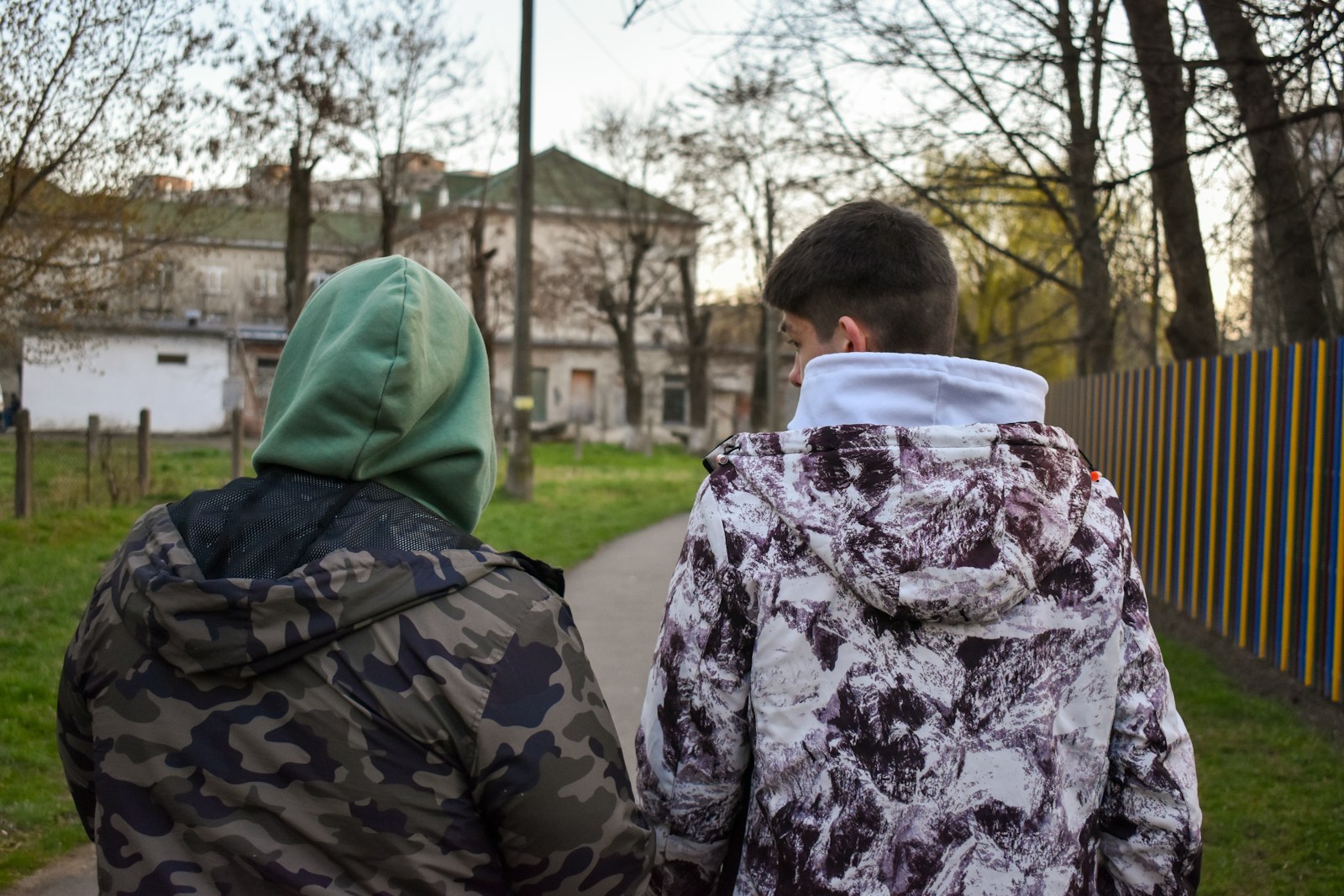 a couple of people that are standing in the grass