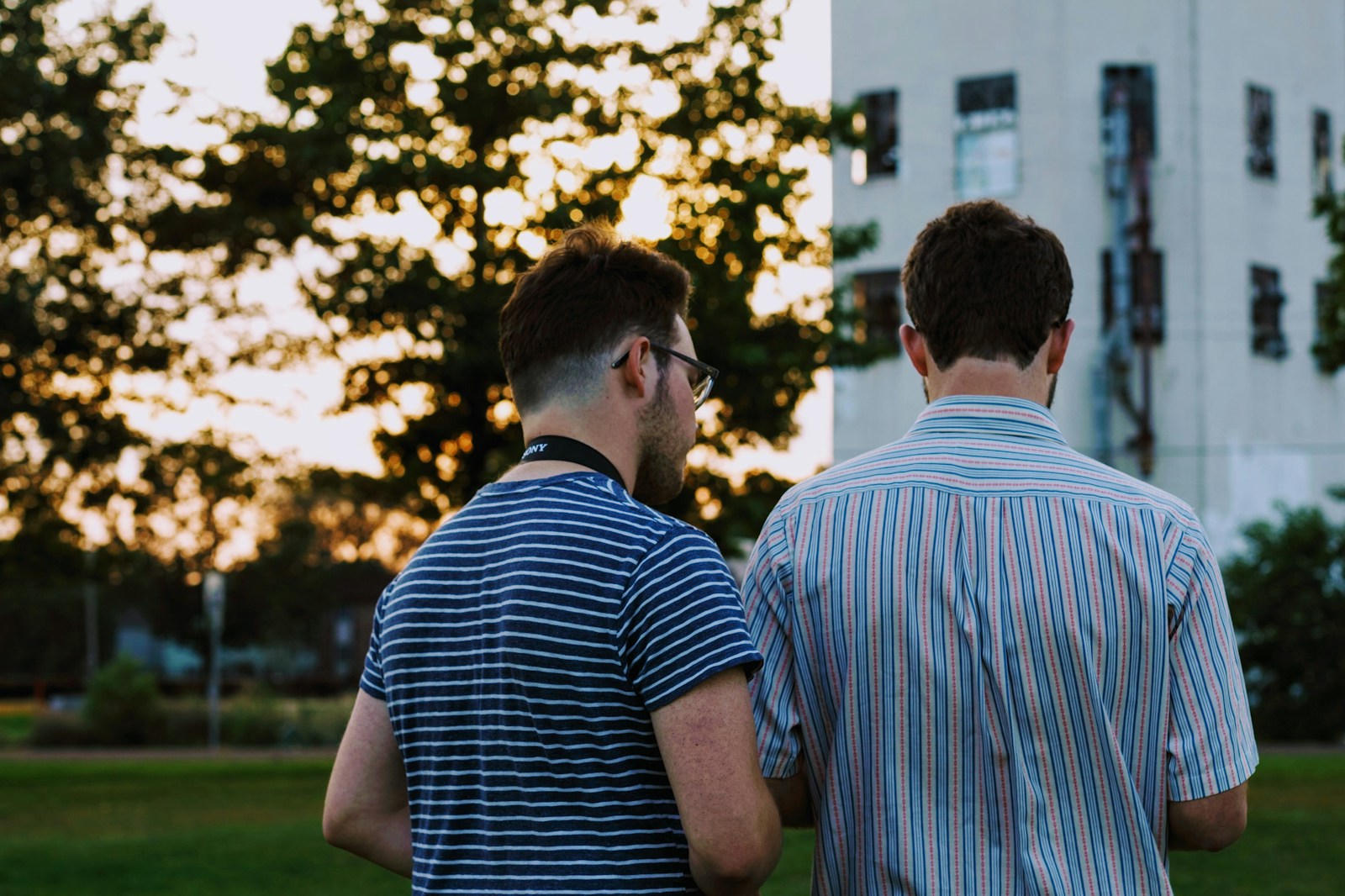 two men wearing striped shirts