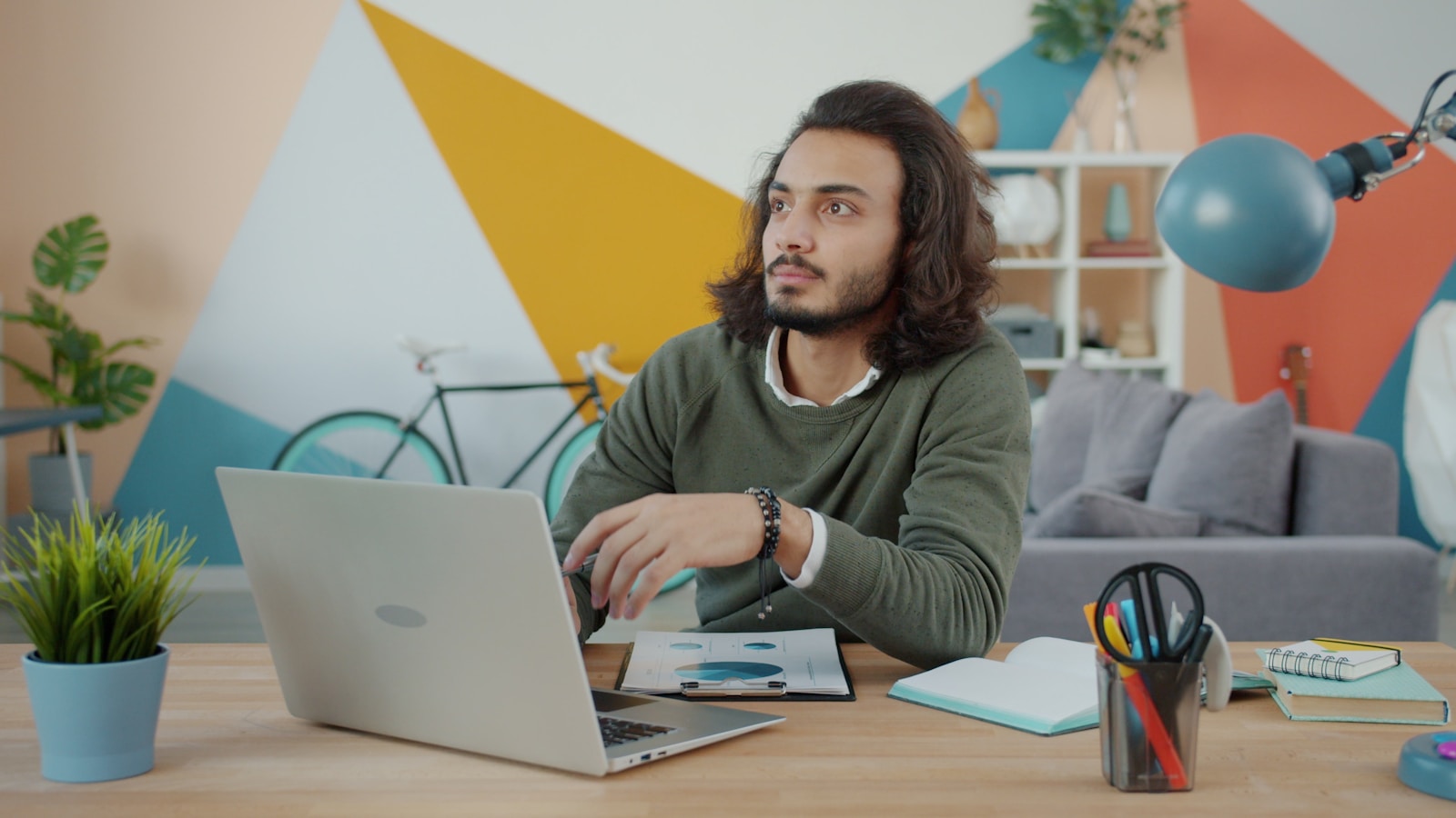 Man working on a laptop at a desk.