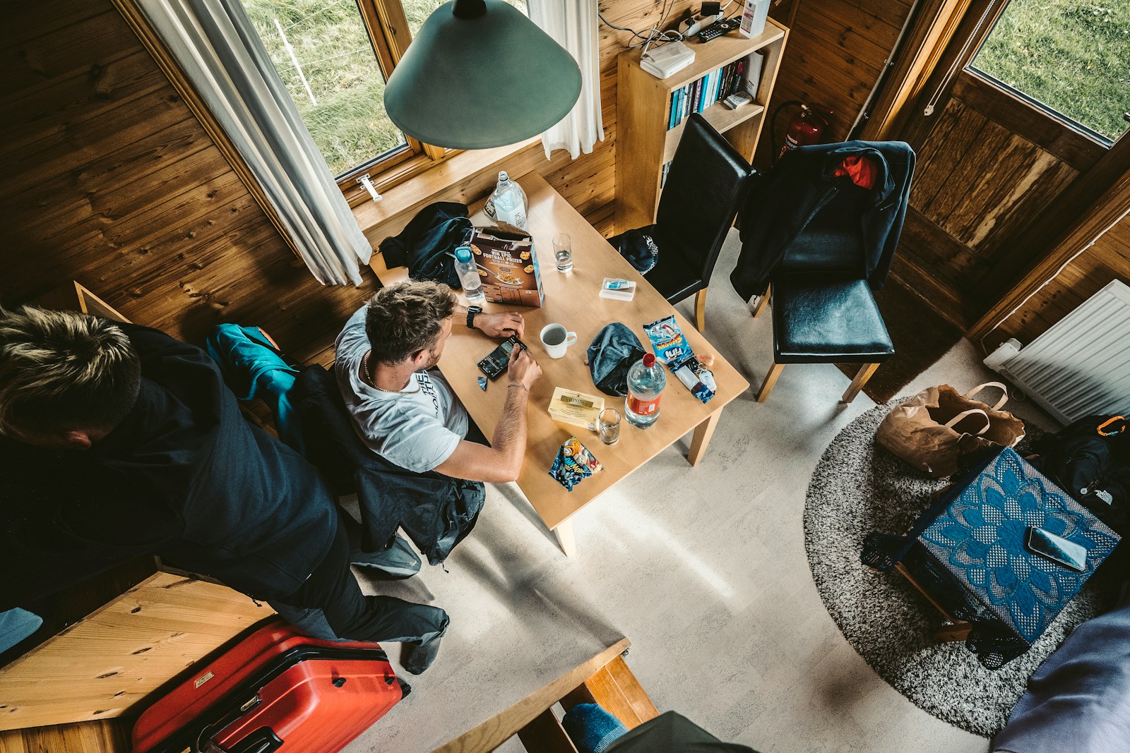 a group of people sitting around a wooden table