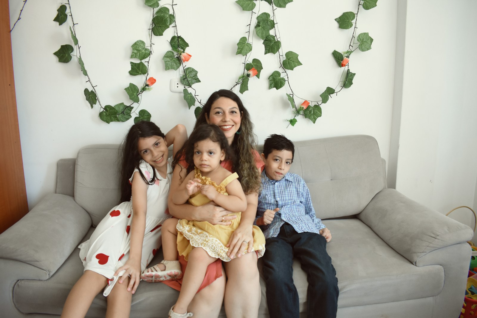 a group of people sitting on a couch posing for the camera