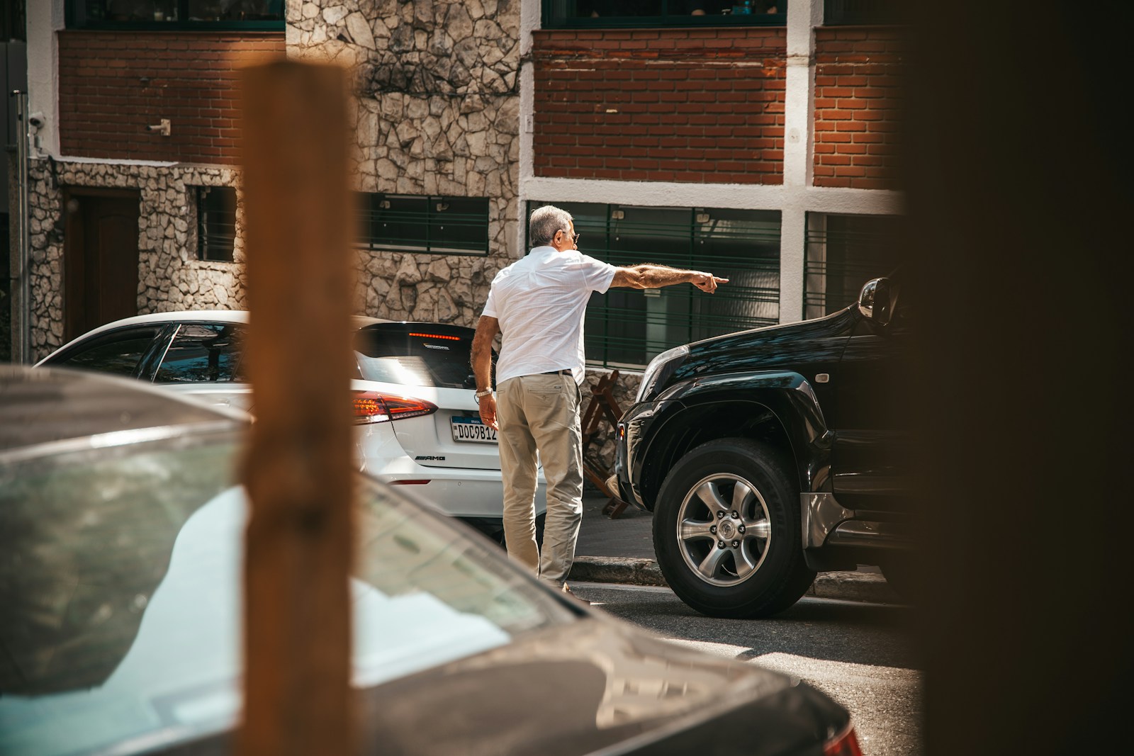 a man standing next to a black truck
