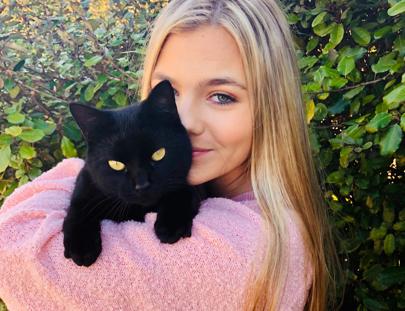 woman with black cat on her lap