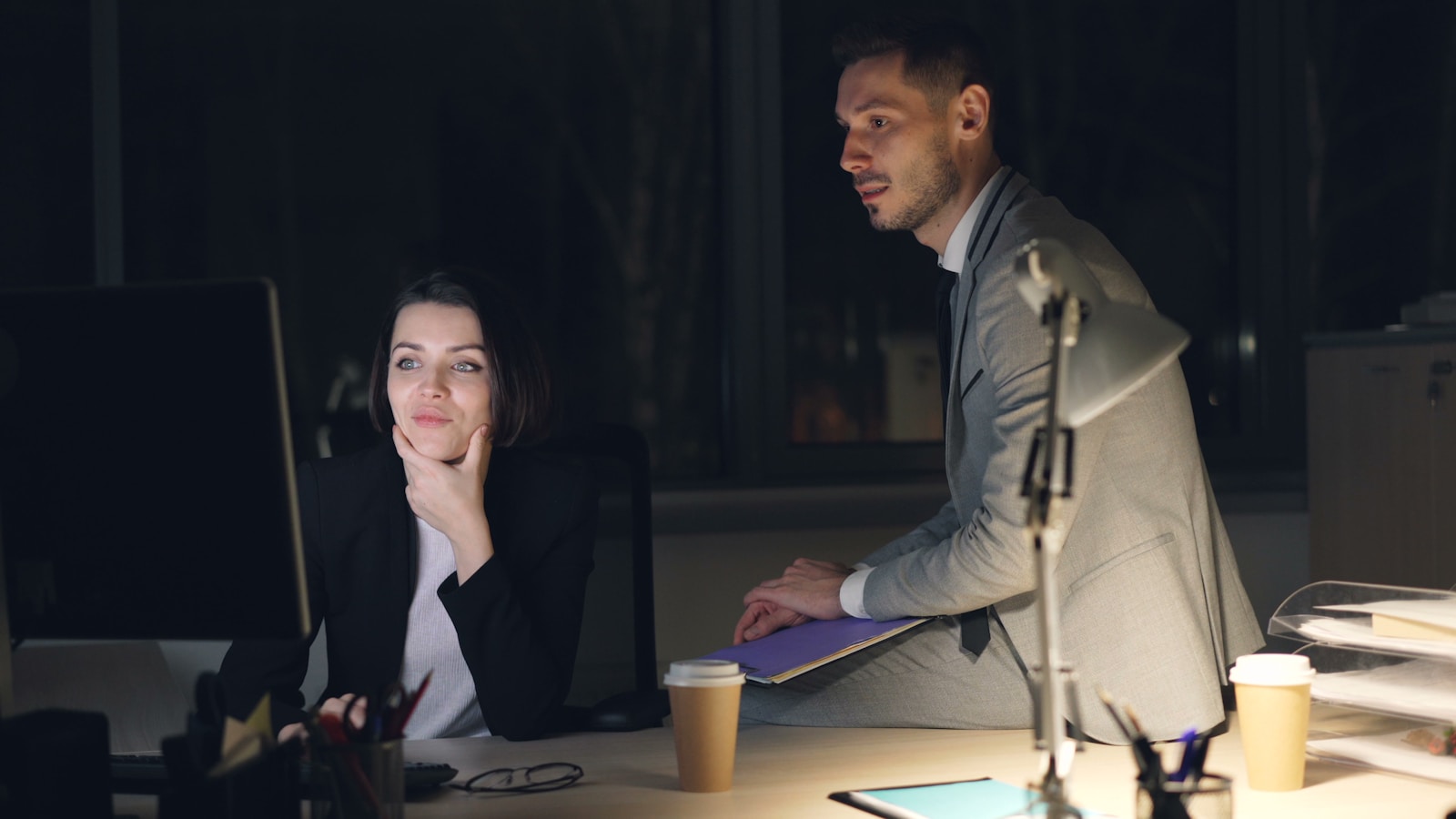 Two colleagues working late at the office.