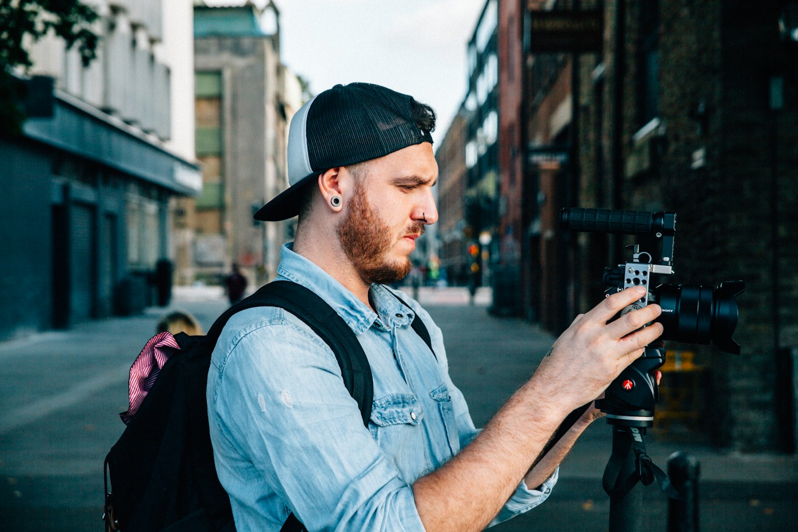 man using black DSLR camera