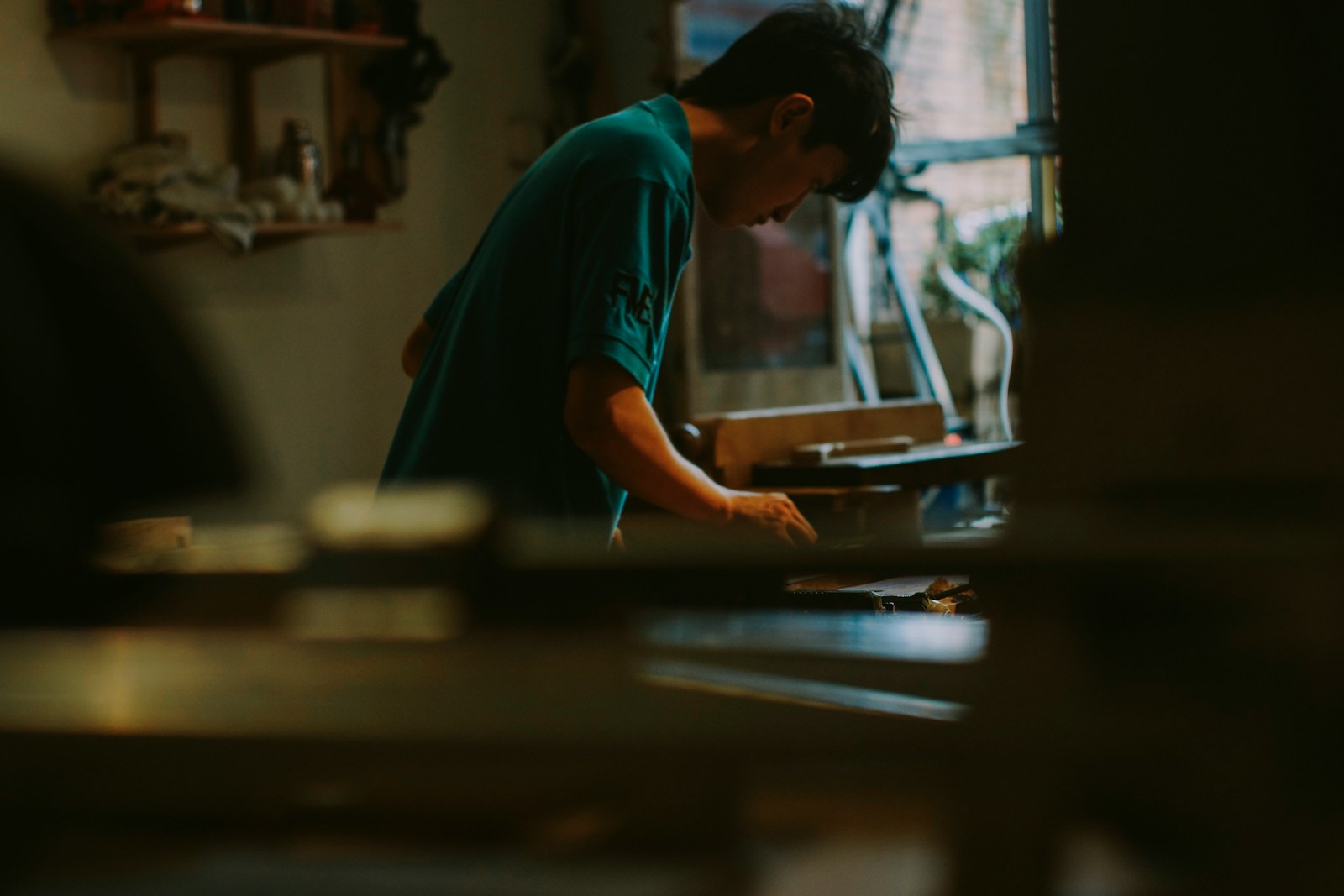 Young person working at a desk with books.