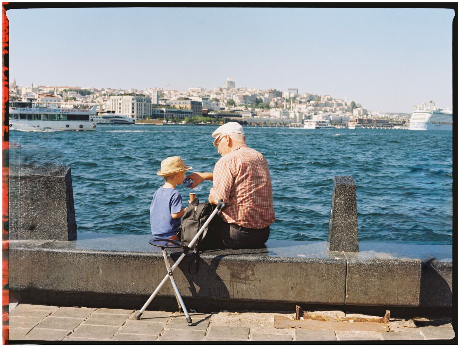 A warm scene of a grandfather and child by the Bosphorus in Istanbul, Türkiye.