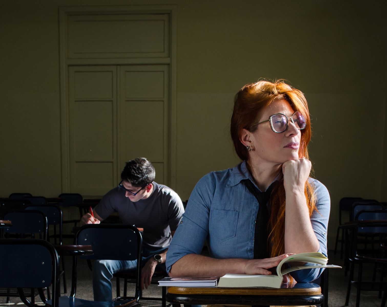 Two students in a contemplative classroom moment, focused and studious in Buenos Aires.