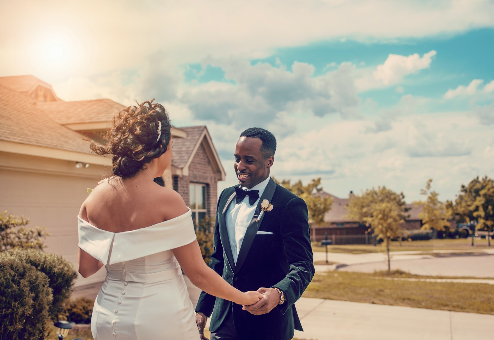 woman in white wedding dress holding man in black suit