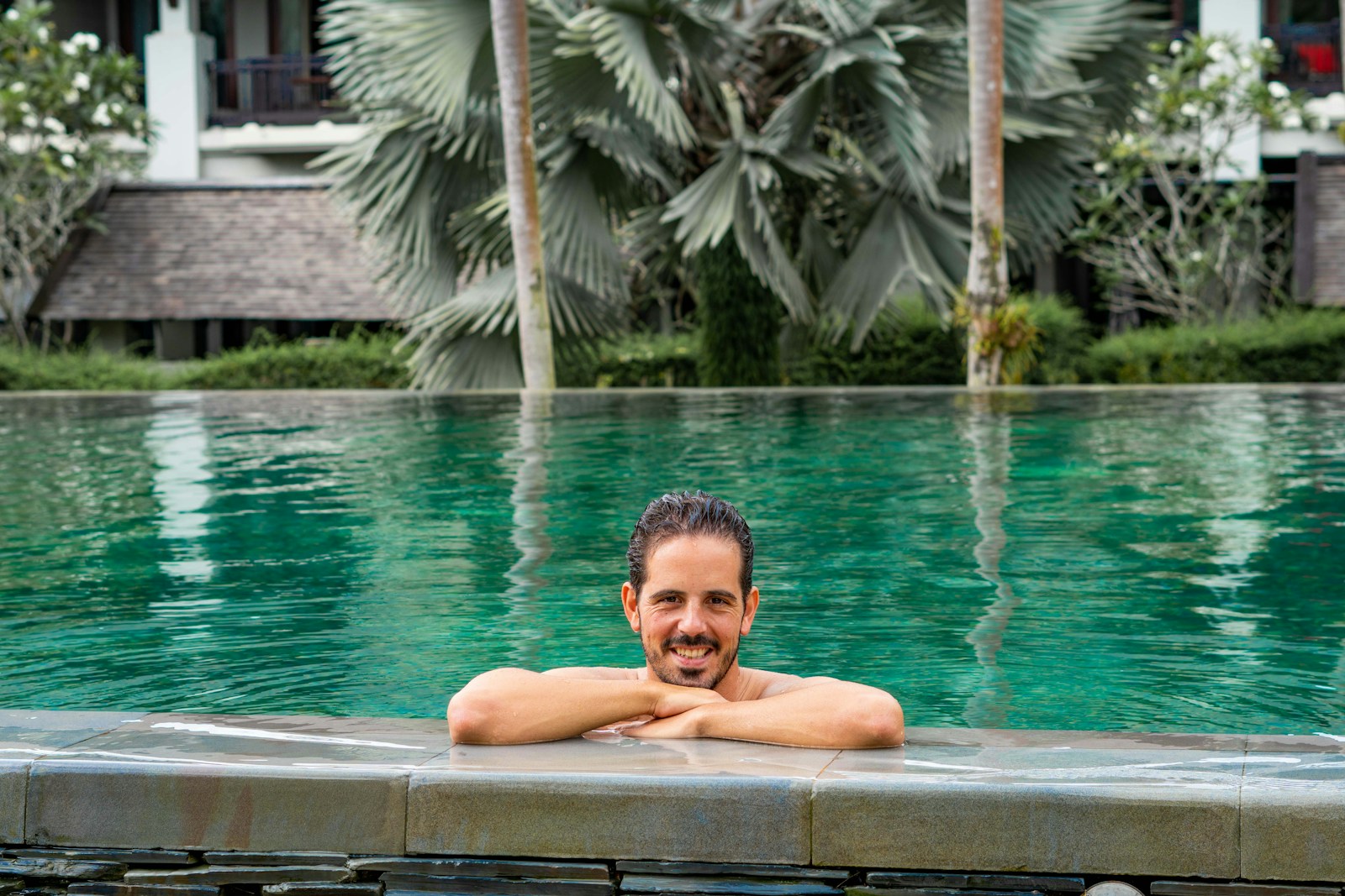 A man sitting in a pool with his arms crossed