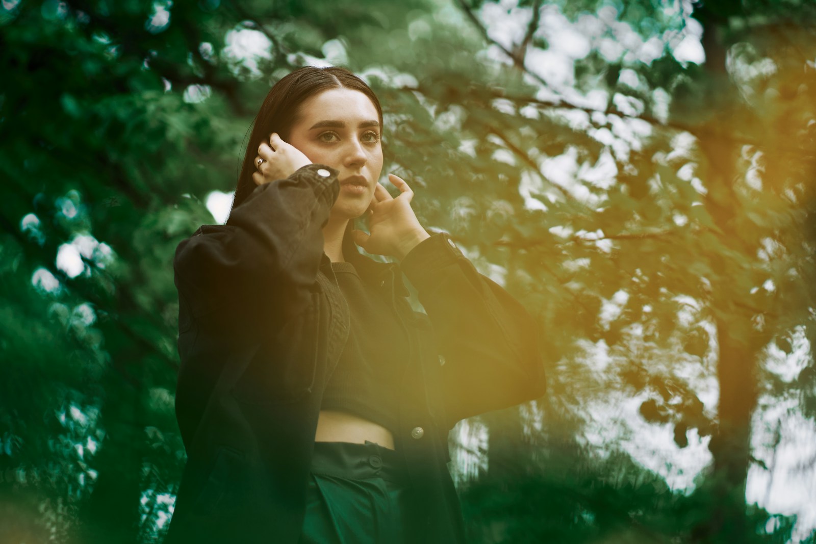 a woman talking on a cell phone in a forest