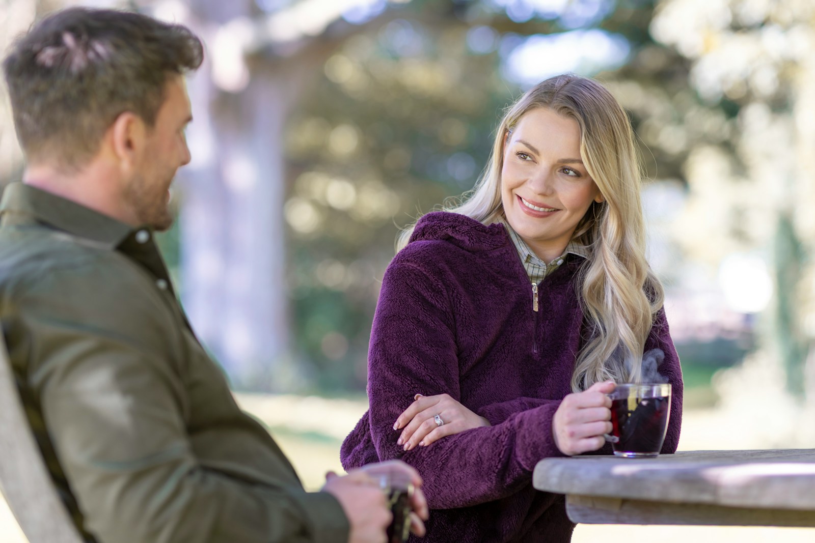 A man and a woman sitting at a table talking