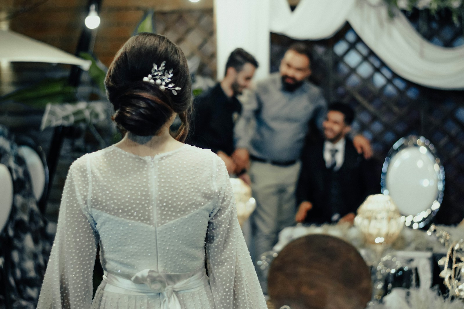 a woman in a white dress standing in front of other people