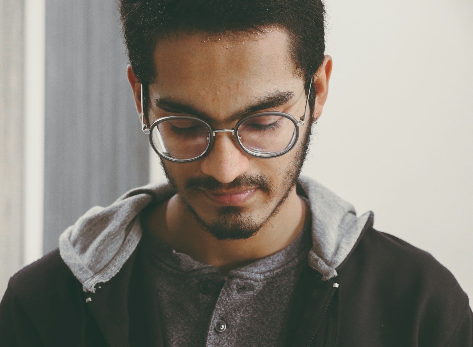 man in black framed eyeglasses and black leather jacket