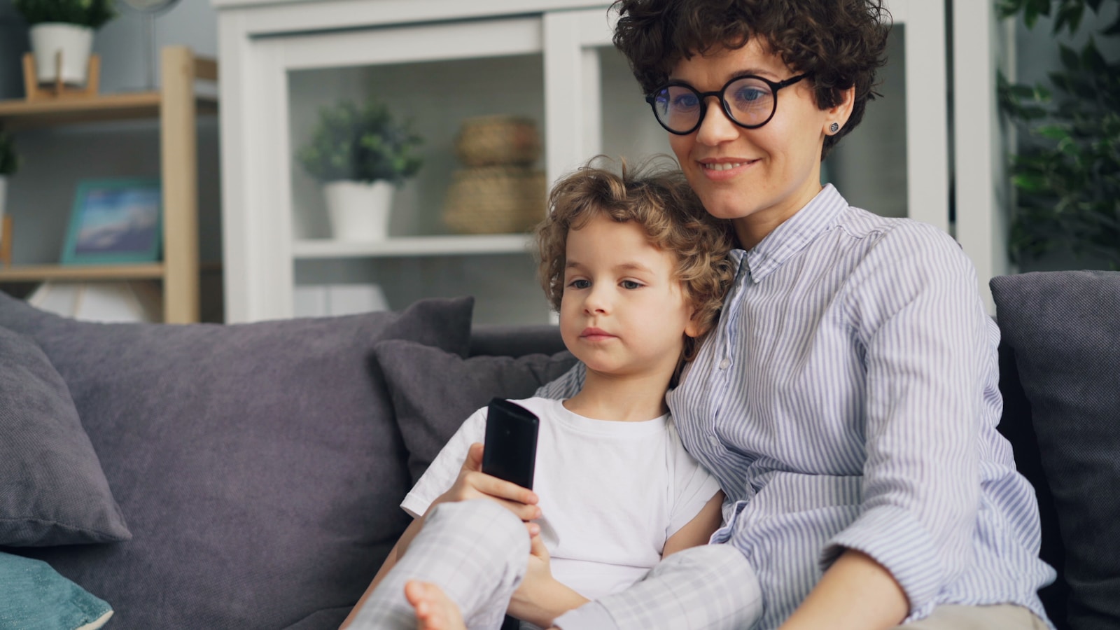 a woman and a child sitting on a couch