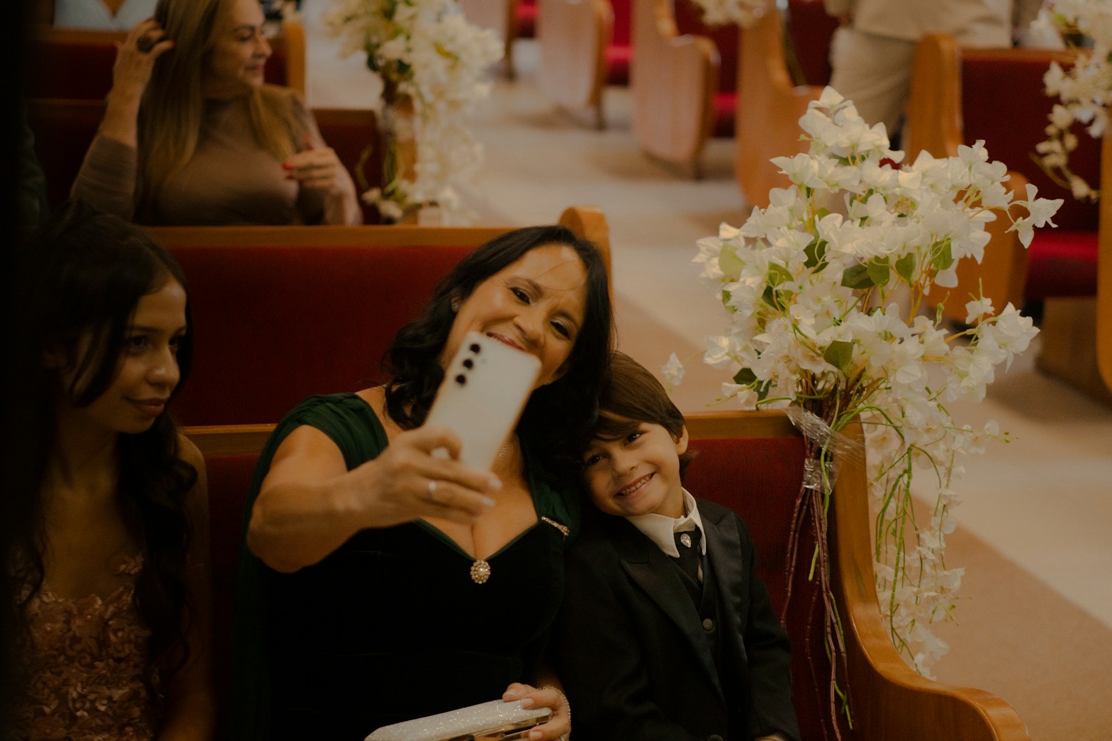 Woman takes selfie with boy in church pew