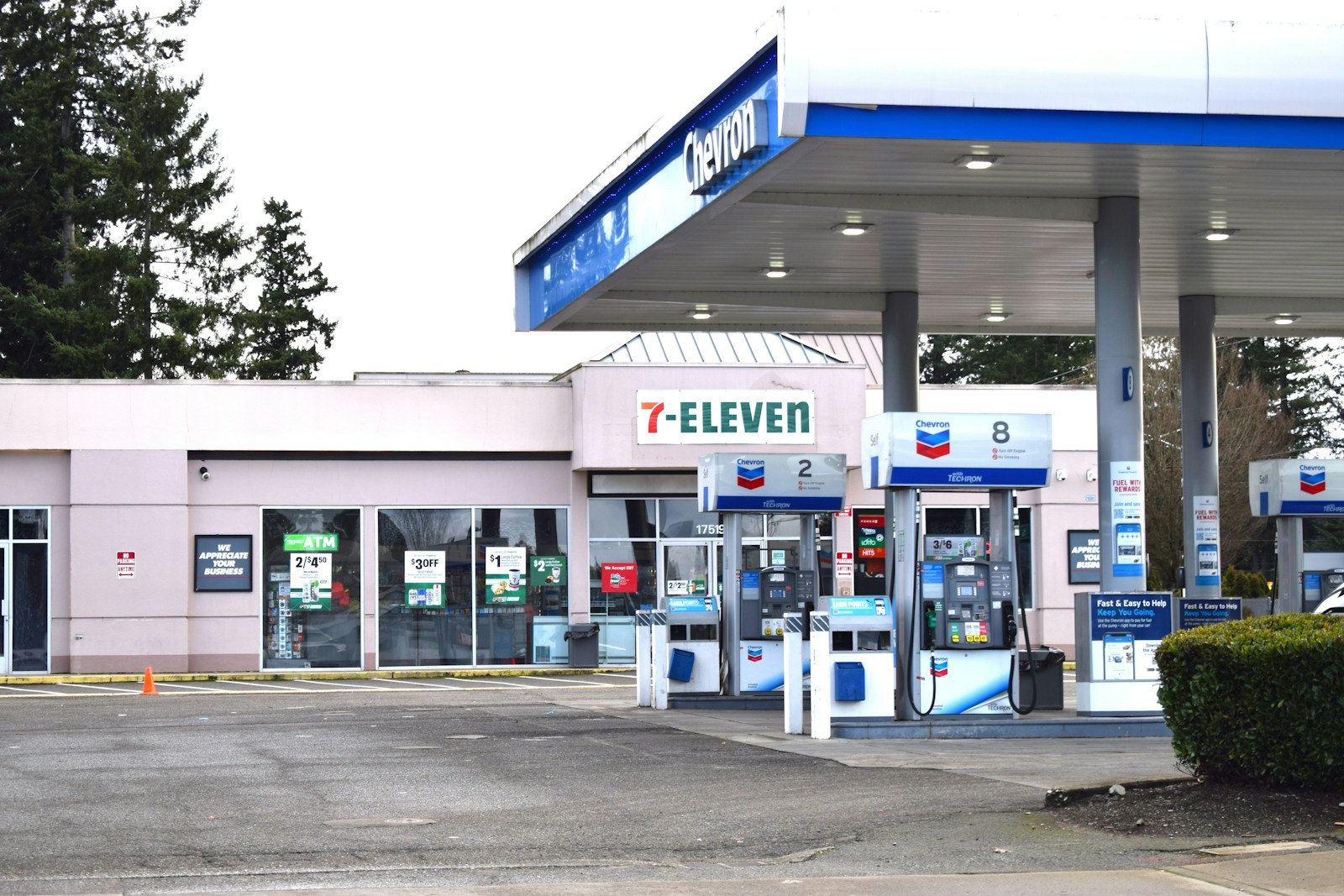 a gas station with a car parked in front of it