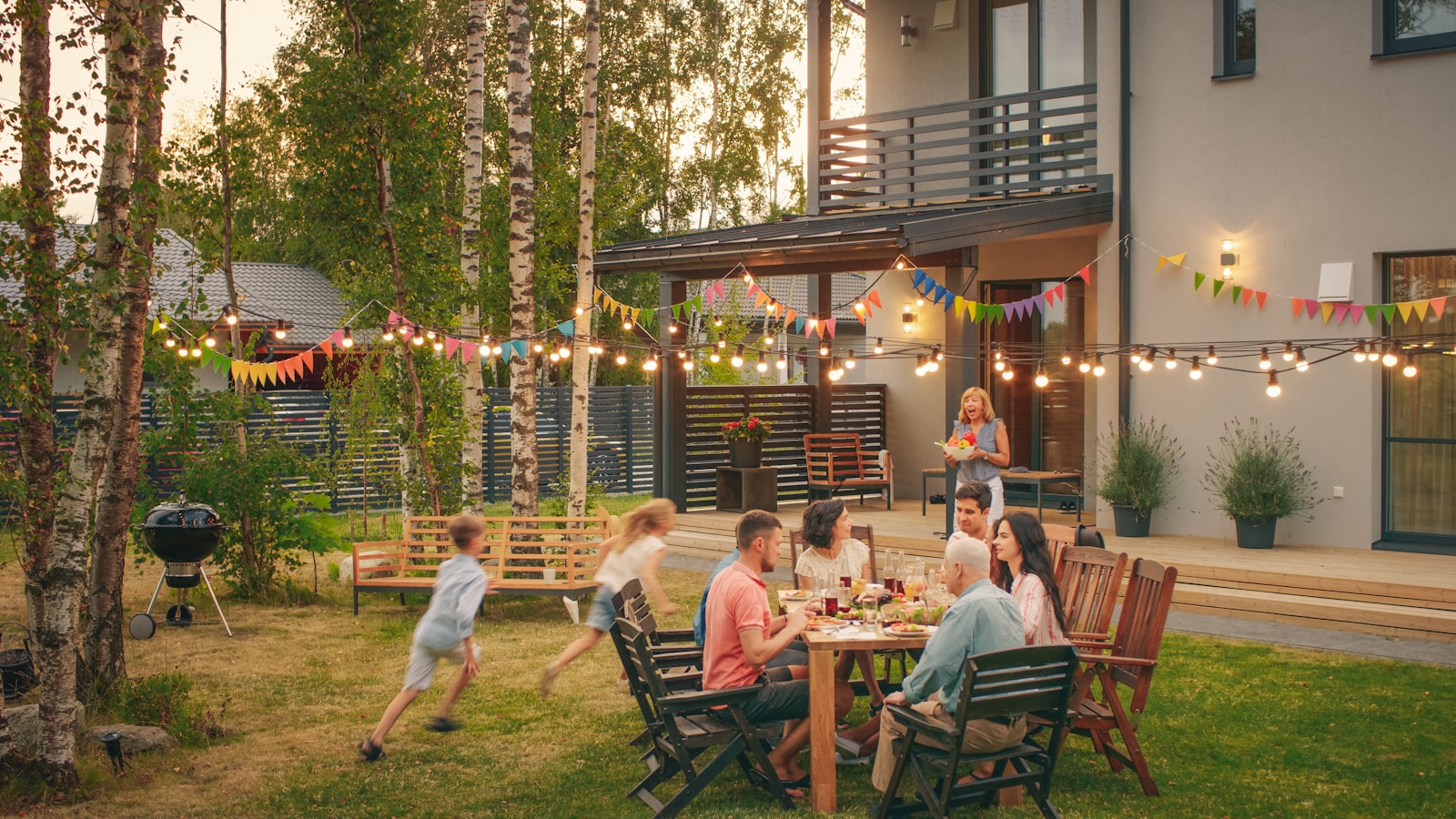 a group of people sitting around a table outside