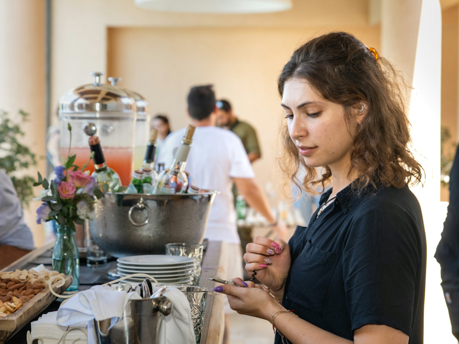 Young woman looking at her hand at a buffet.