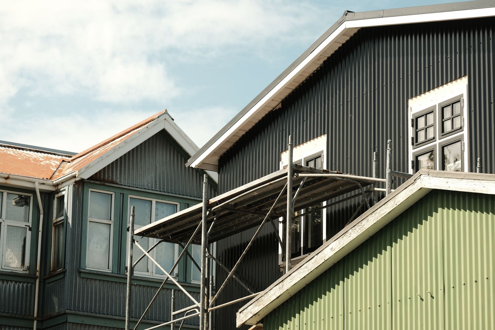 Scandinavian architecture in Reykjavík with colorful corrugated metal siding, captured in bright daylight.