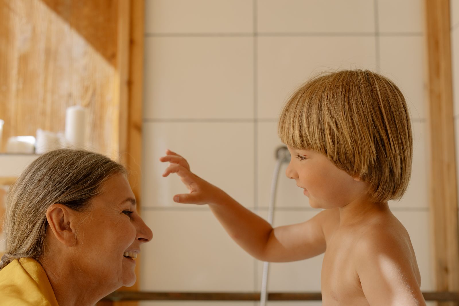 Heartwarming scene of a grandmother and grandson enjoying time together indoors.