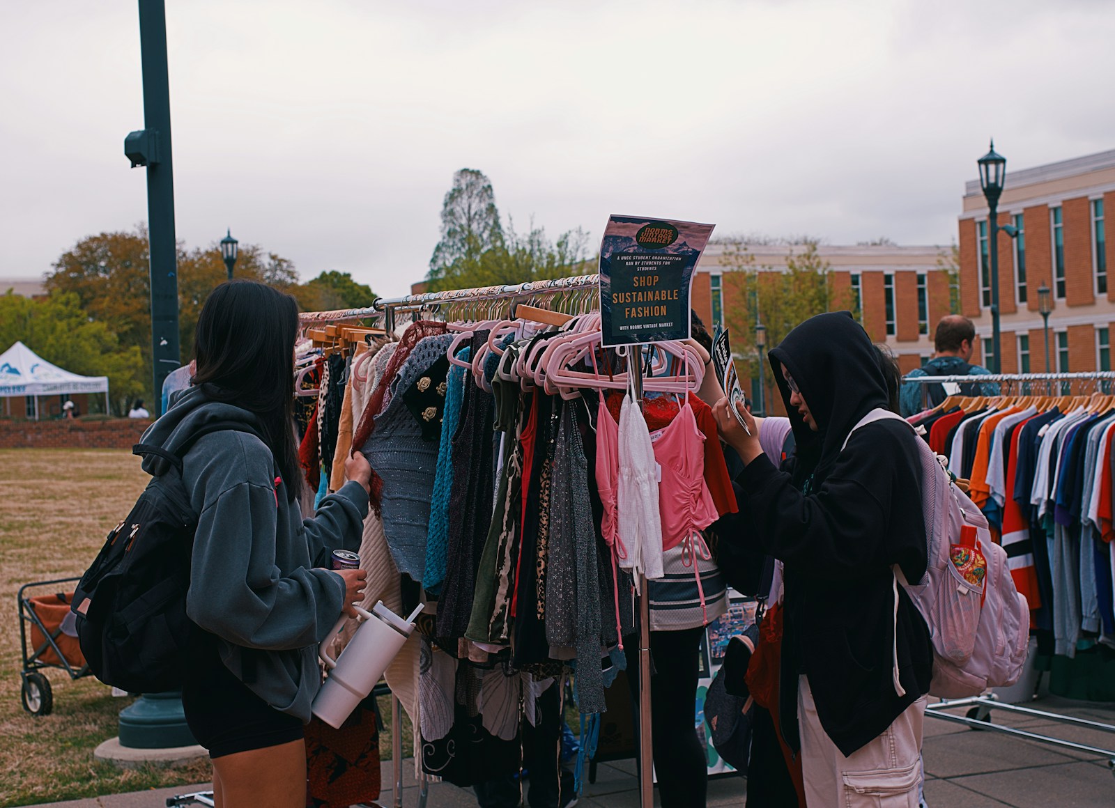 People browse clothes at an outdoor pop-up shop