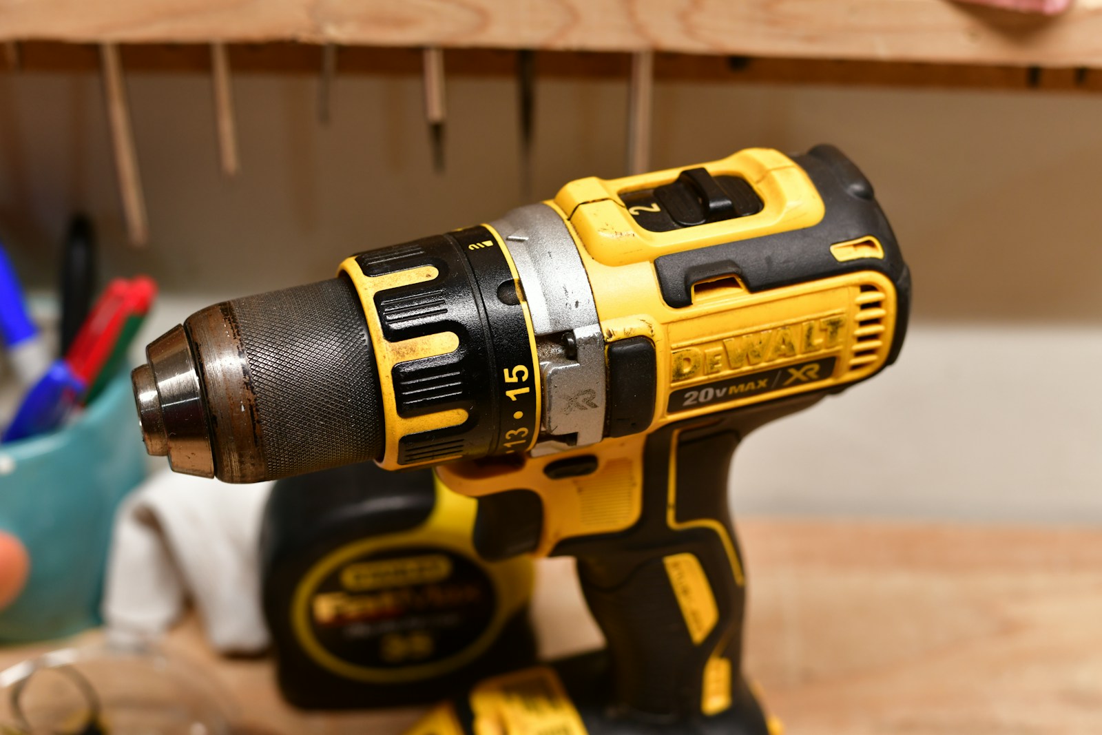 Yellow and black cordless power drill on a workbench
