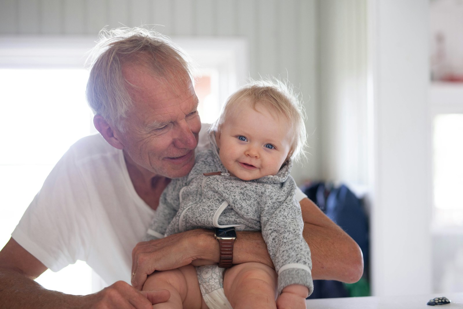 a man holding a baby in his arms