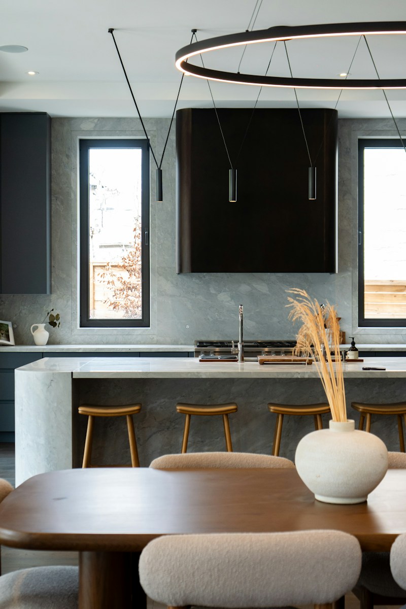 Modern kitchen with island, pendant lights, and bar stools
