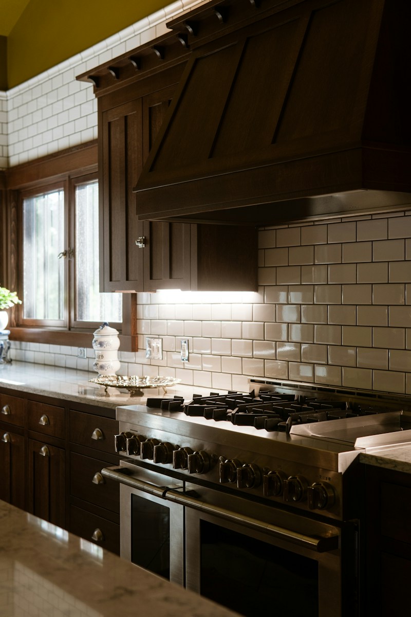 A kitchen with a stove top oven and a sink