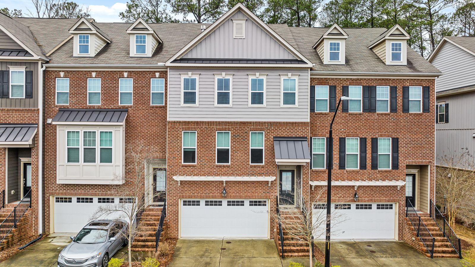 Discover charming brick townhouses with modern design in a peaceful suburban neighborhood.