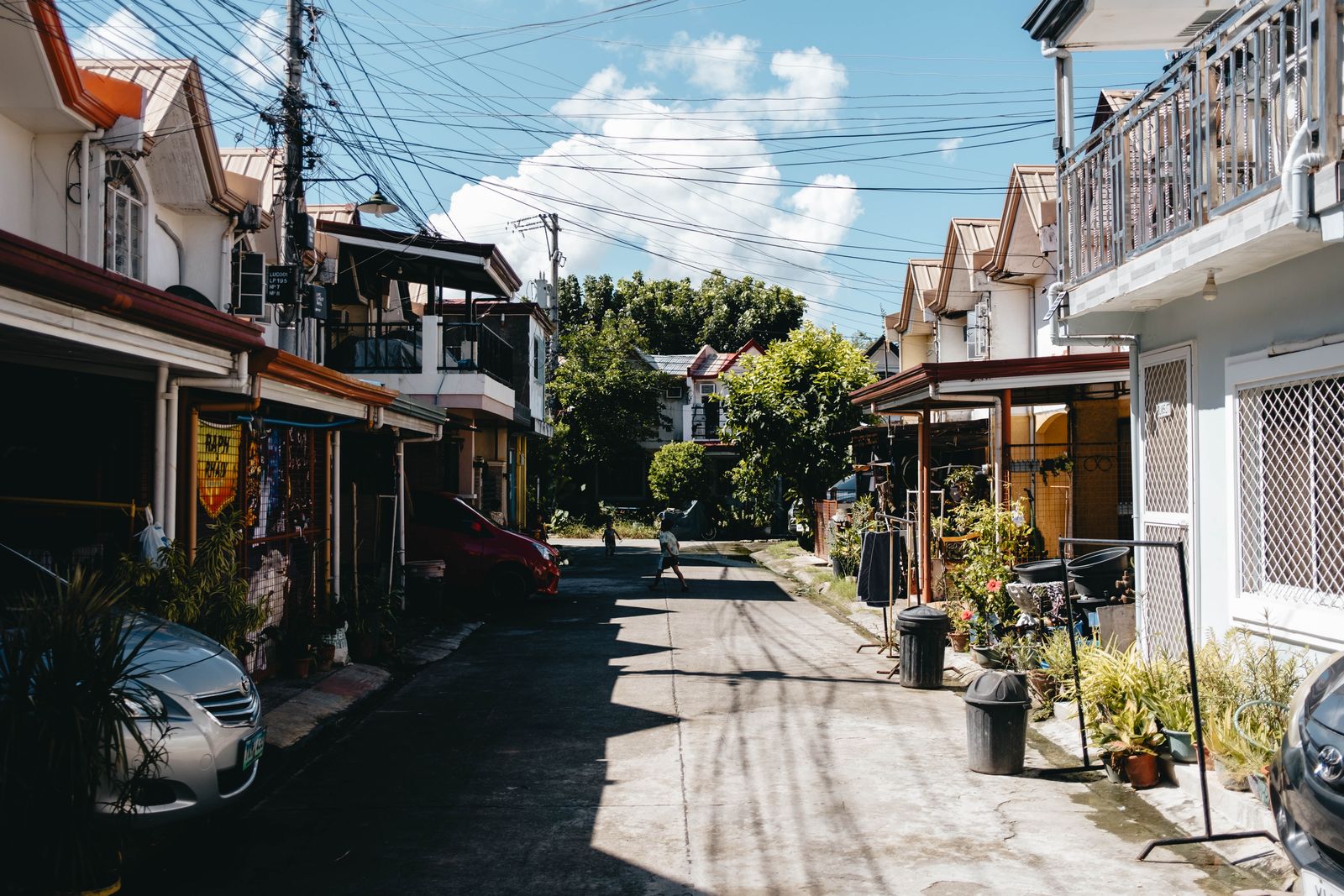 Charming neighborhood street with traditional houses on a sunny day.