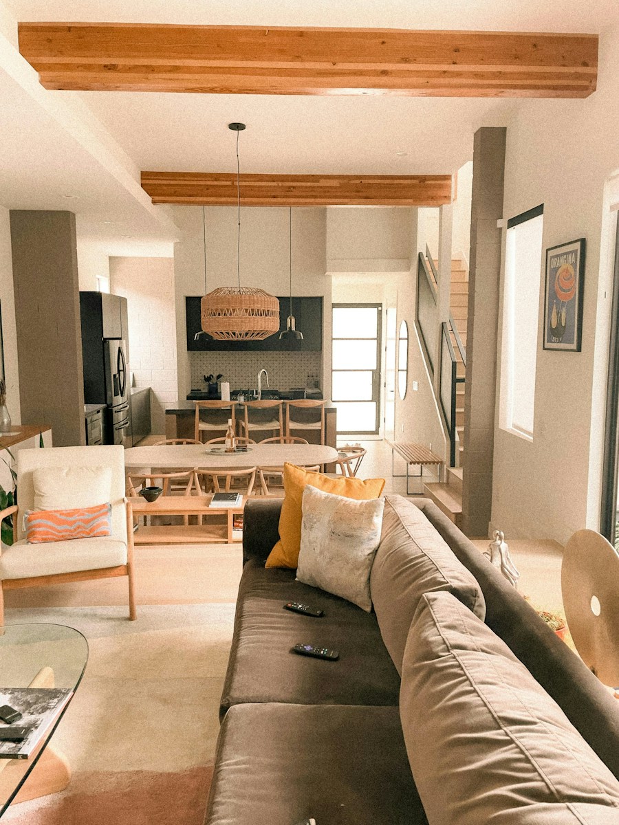 Modern living room with open kitchen and wooden beams