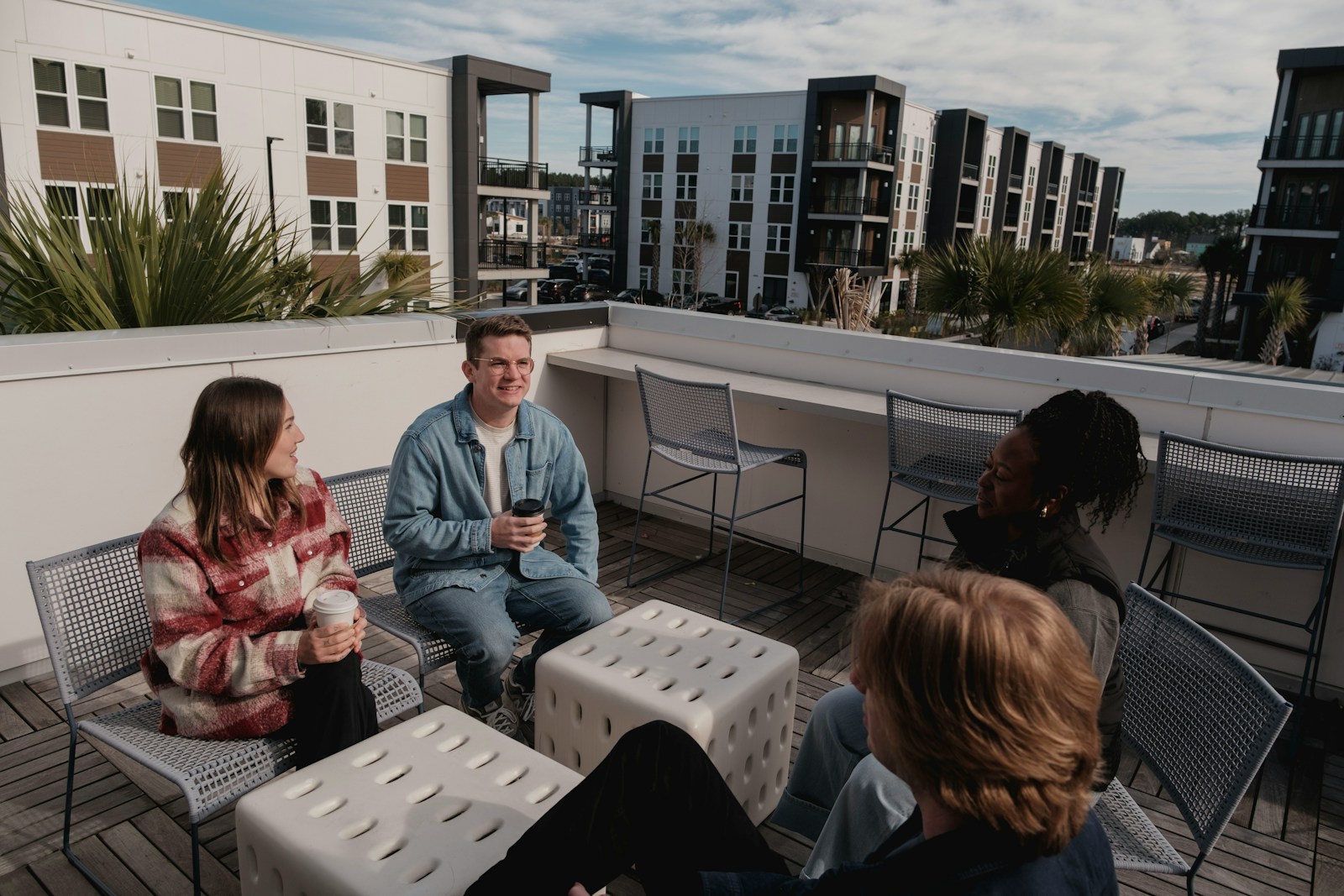 Group of friends relaxing on a rooftop patio