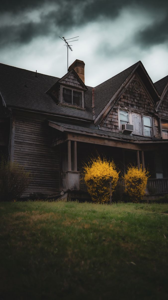 A dark, moody photograph of a Gothic-style house with ominous skies in London, Ohio.