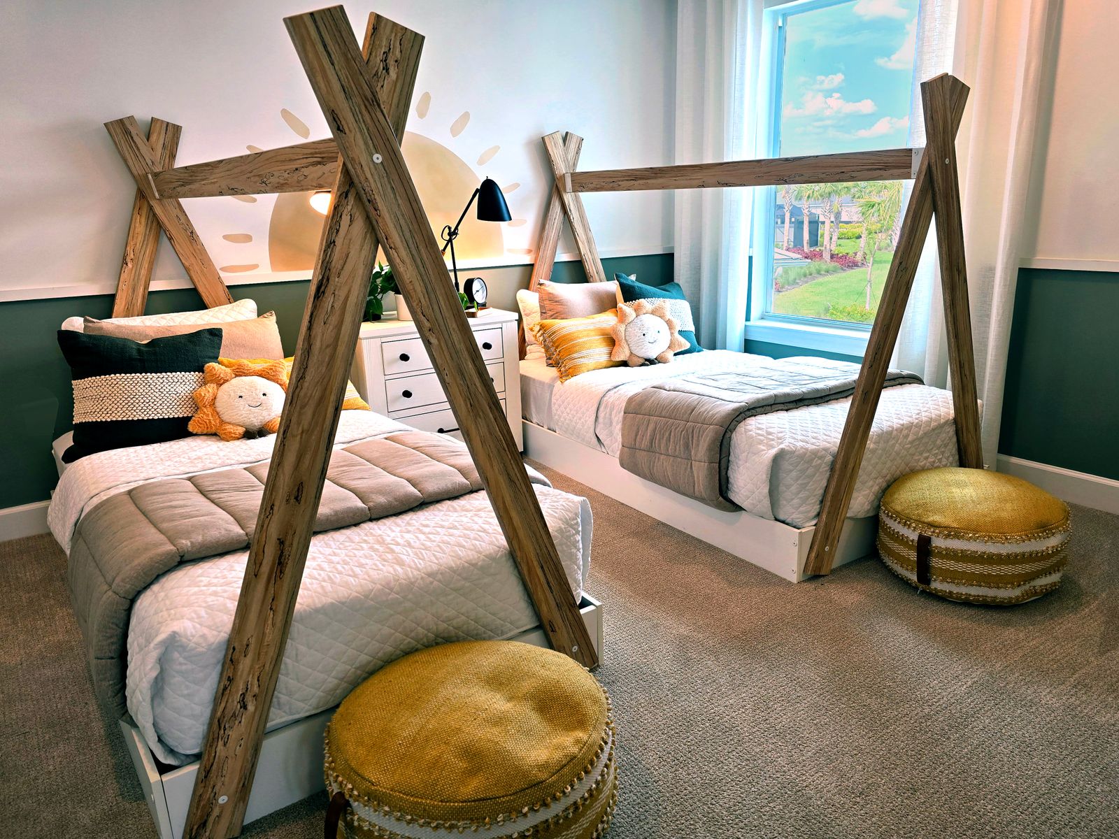 Modern kids' bedroom featuring twin wooden canopy beds and cheerful decor.