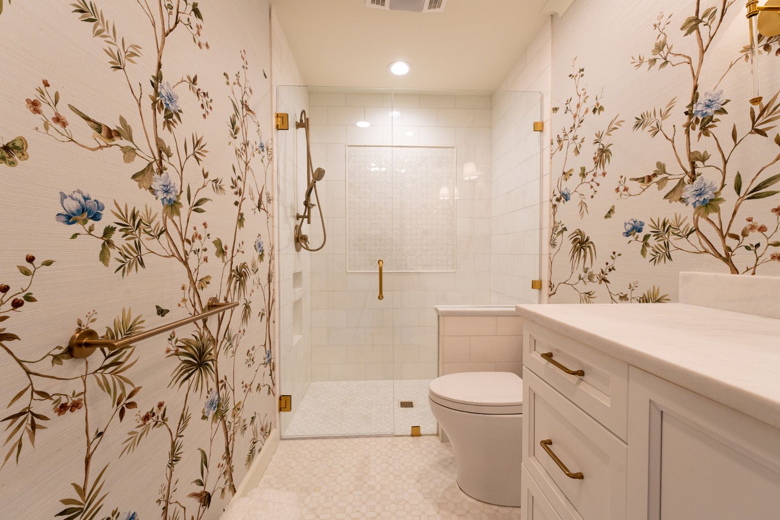 Luxurious bathroom with floral wallpaper and modern fixtures, showcasing elegant interior design.