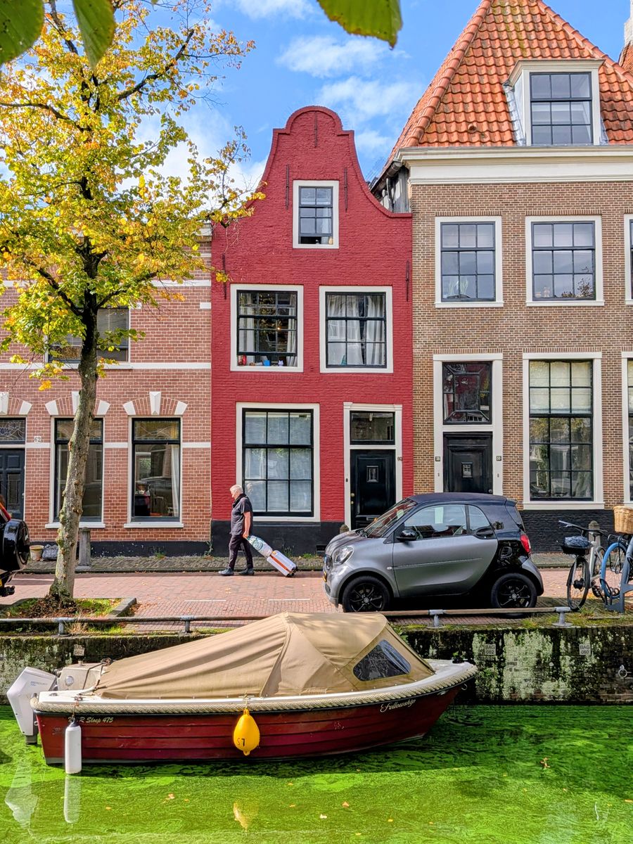 A vibrant canal scene in Haarlem, showcasing classic Dutch architecture and lifestyle by the water.