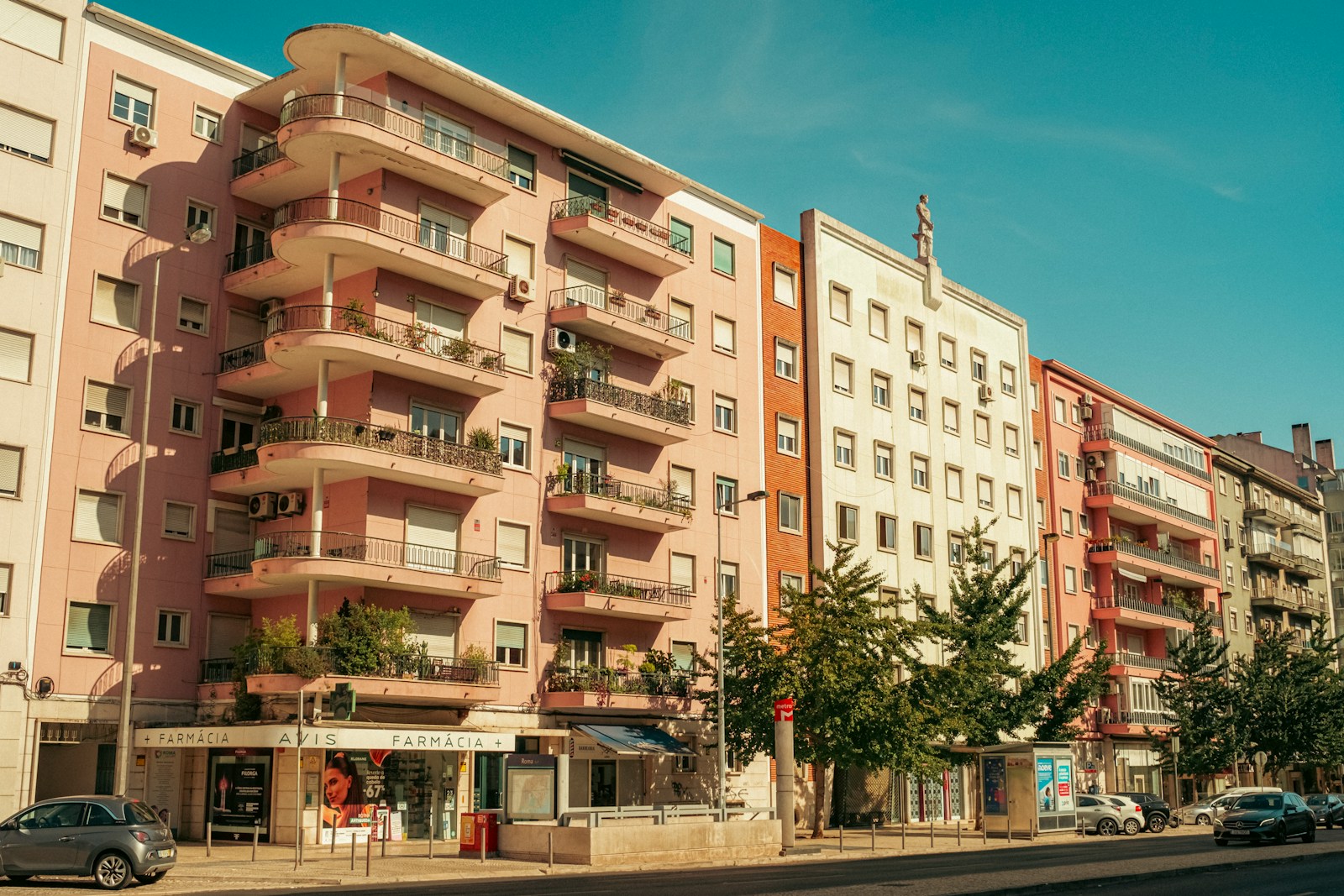 Row of apartment buildings with balconies and shops