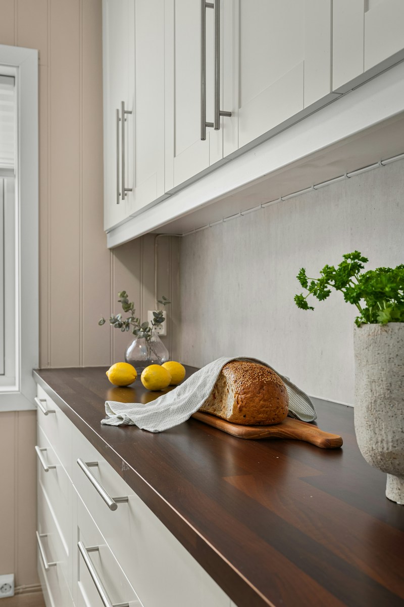 A kitchen counter with a loaf of bread on it