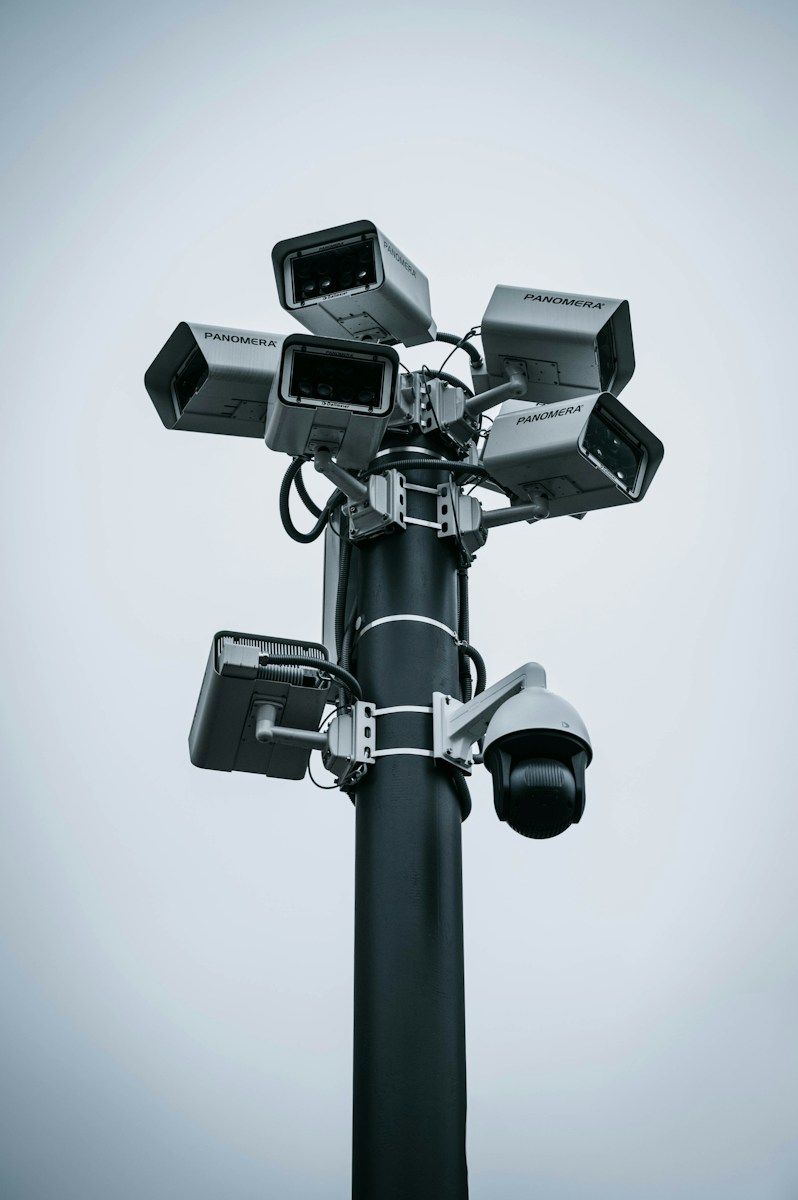 A tall pole mounted with multiple Panomera surveillance cameras against a grey sky