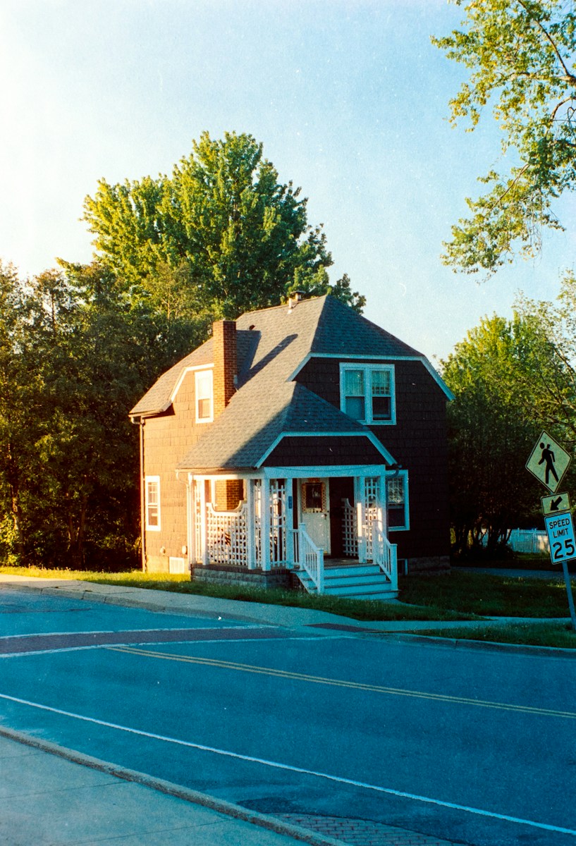 A small house on the corner of a street
