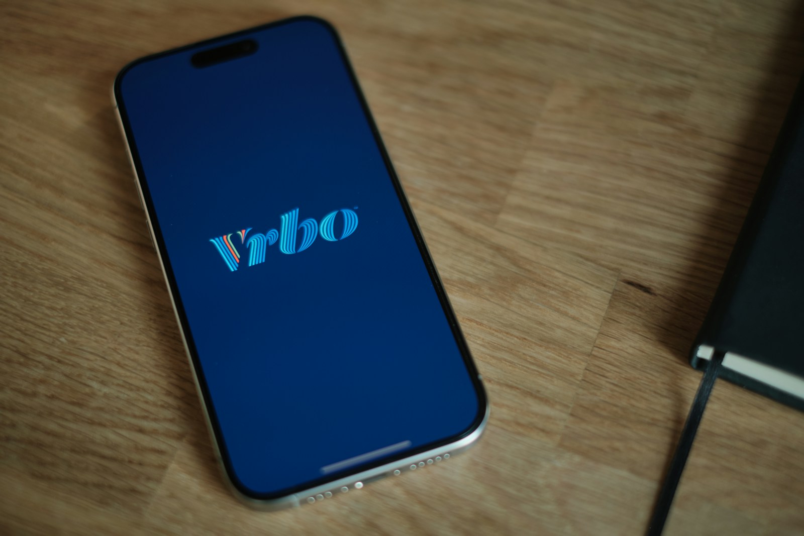 A cell phone sitting on top of a wooden table